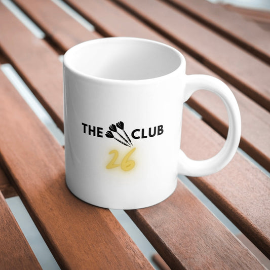 White mug with 'The Club 26' logo on a wooden surface
